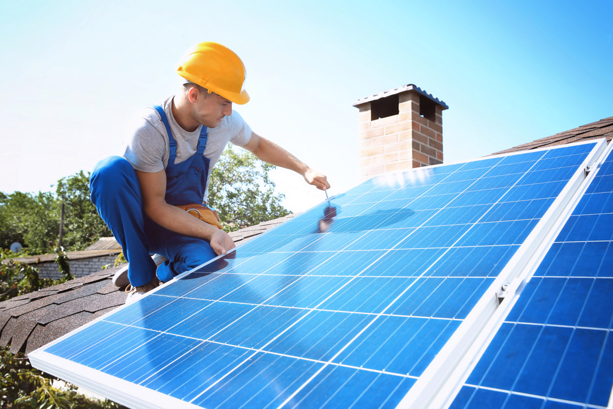 Solar company installing solar panels on roof of home